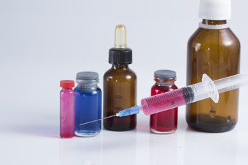 medical ampoules and syringe isolated on white background.