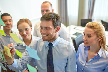 smiling business people with marker and stickers