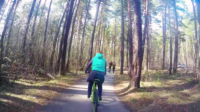 Woman riding bicycles on a city park in slowmotion, 1920x1080