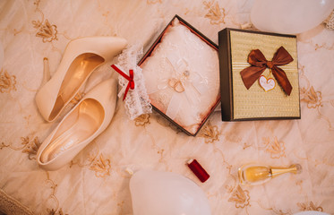 bride accessories. two rings on white pillow. Bride shoes.