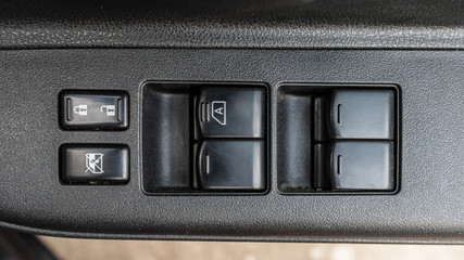 Button in car for adjust windows and lock the door.