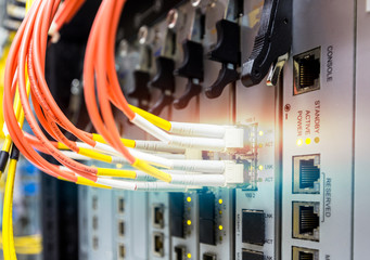 Fiber optic cable connect to ethernet switch mount on rack.