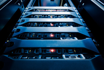 Computer Server mount on rack in data center room with red lighting alarm..