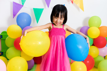 Fototapeta na wymiar Asian Little Chinese Girl Playing with Colorful Balloons