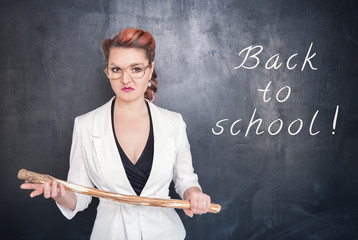 Angry teacher with wooden stick on chalkboard