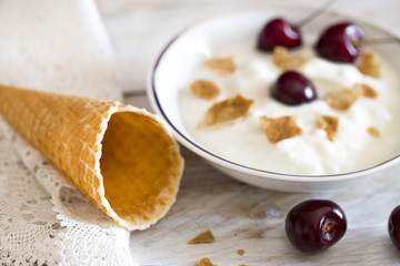 Waffle cones and cherry on the wood
