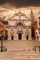 Fototapeta na wymiar Campo San Moise and Facade of Chiesa di San Moise, a Roman Catholic church built in the Baroque style in the 8th century, located near the Piazza San Marco. In sunrise. Dramatic sky. Venice, Italy.