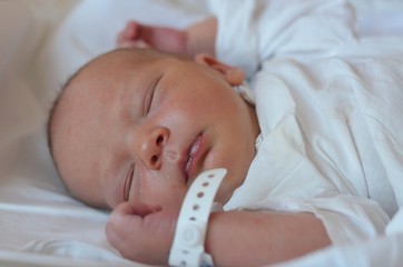 Close up portrait of two days old newborn boy in a hospital