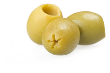 Pitted green olives close up on the white