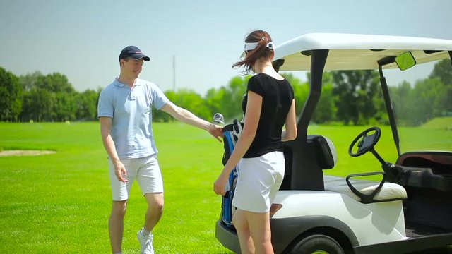 Young couple go to play golf