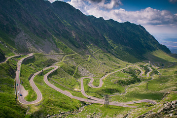 View from a halting place in Fagaras mountains of a curvy highway. Transfagarasan road. Fagaras Mountains Beautiful view of Balea Lake and Balea cottage Carpathians Mountains
