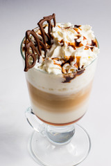 coffee with whipped cream,layers liqueur and milk in a transparent glass