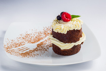 classic cupcakes with red currants on a white serving dishes