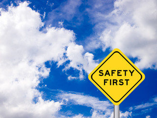 wording "Safety first" on yellow traffic sign on the blue sky