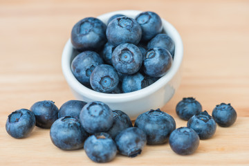 Blueberry in a bowl on wooden table background