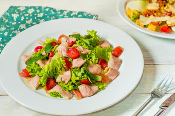 dish of salad with vegetables and meat