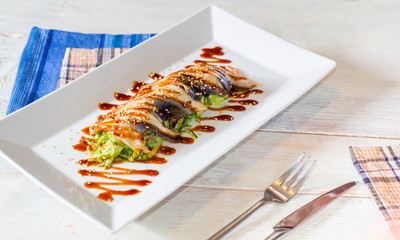 Serving a wooden table with a plate of fish snacks