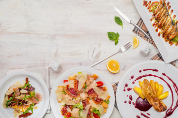 views directly over wooden table with a variety  French cuisine