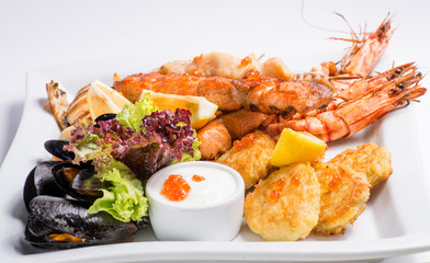 set of grilled  seafood grilled on a white plate. Serving for the restaurant menu