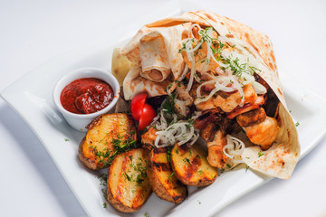 grilled meat and potatoes on a white plate. Serving for the restaurant menu