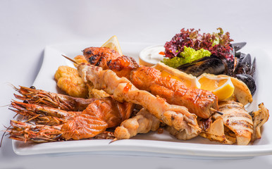set of grilled  seafood grilled on a white plate. Serving for the restaurant menu
