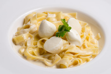 pasta with cream sauce in white plate. Serving for the restaurant menu