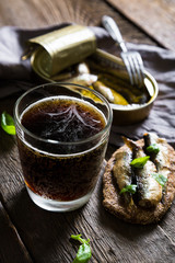 Dark beer with a fish sandwich