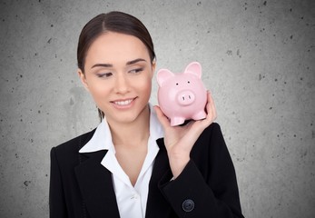 Woman holds pigy bank.