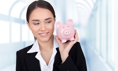 Woman holds pigy bank.