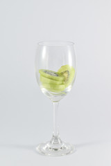 kiwi fruit in a glass wine isolated on white background.