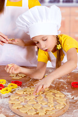 little chefs cook the biscuits, cut dough figurines