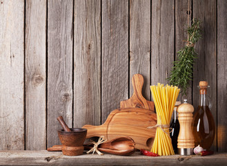 Fototapeta na wymiar Kitchen utensils, herbs and spices on shelf