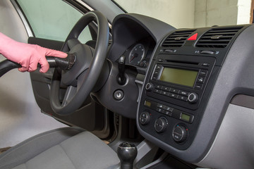 Car steering wheels cleaning from dust with special vacuum cleaner nozzle. Early spring cleaning or regular clean up.
