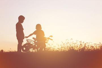 Naklejka na ściany i meble two little boys bike silhouette