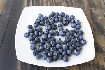 Ripe Blueberries on a White Plate