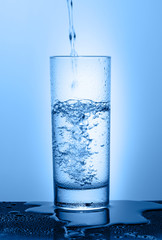 Beautiful glass with water on a blue background