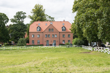 beautiful red brick house standing at a meadow