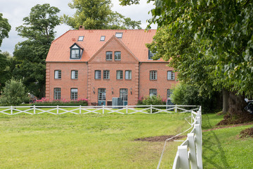 beautiful red brick house standing at a meadow