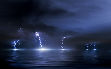 Naklejka na ściany i meble Thunderstorm over the sea, lightning beats the water