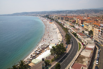 Fototapeta na wymiar The Promenade d'Anglais of Nice in France seen from above with the beach and sea next to it 