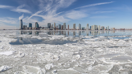 View from Manhattan New York City to Jersey City across the frozen Hudson river in winter. February 2015 - obrazy, fototapety, plakaty