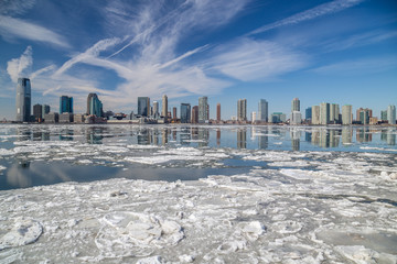 View from Manhattan New York City to Jersey City across the frozen Hudson river in winter. February 2015 - obrazy, fototapety, plakaty