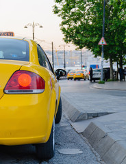 Red brake light yellow taxi on a background of an evening in Istanbul