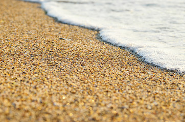 Tidal wave on a clean, sandy, sea beach