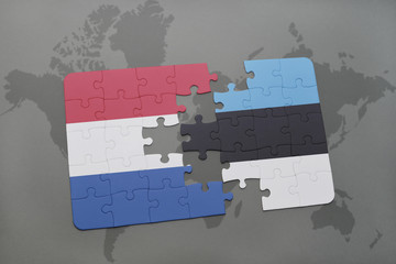 puzzle with the national flag of netherlands and estonia on a world map background.
