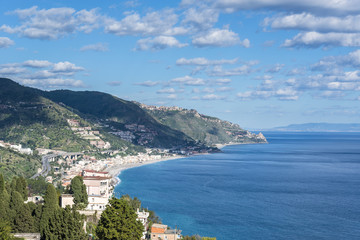 Naklejka na ściany i meble Panoramic view of the Taormina Mediterranean coastline, Province of Messina. Sicily, Italy.