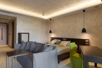 Bedroom with double bed and living room in hotel suite
