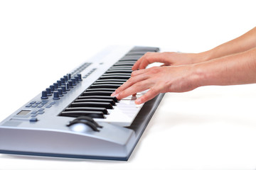 Fototapeta na wymiar Man playing on a synthesizer