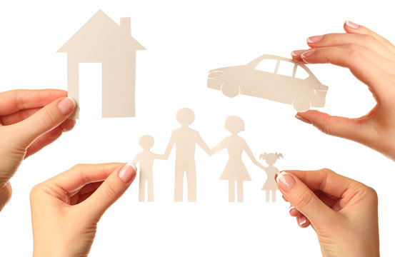 Hand holding a paper home, car, family on white background