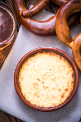 Hot cheese fondue with pretzel